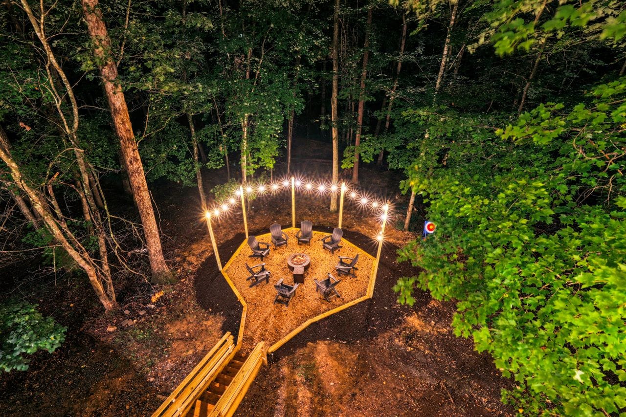 Backyard fire pit clearing at night, aerial view